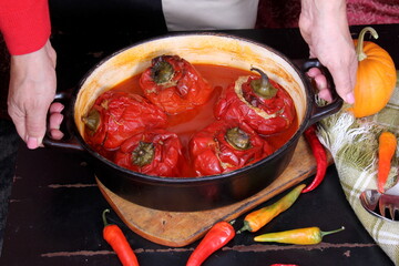 Stuffed bell peppers with meat and rice in tomato sauce, and spicy seasoning. homemade vegetarian dinner - baked colorful paprika stuffed with rice