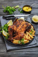 whole crispy skin roasted chicken on a platter