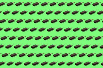 Pattern of ice cream in chocolate glaze. Fashionable ice cream in chocolate glaze pattern on a bright green background.