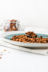 Granola or baked oat flakes with chocolate and nuts. Healthy and simple breakfast.