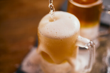 mug of beer on wooden table.