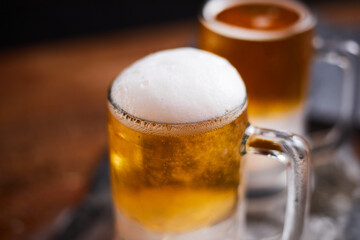 mug of beer on wooden table.
