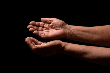 Old lady hands with open palms. Elderly lady is waiting for help. Elderly, aging concept. Wrinkled hands palms reaching out forward. Old lady arms. Old man hands on a black background