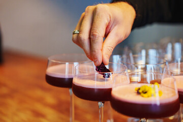 Creative cocktail preparation with edible garnishes at a trendy bar
