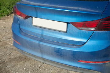 Blue dirty car in the outdoors.