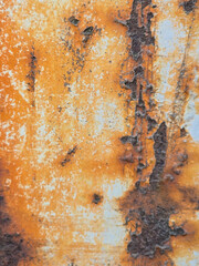 Close-up of rusted metal surface with peeling paint.
