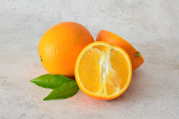 Close-up of fresh, juicy oranges, one whole and one cut open, with a realistic design style