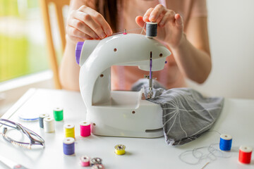 Seamstress working with sewing machine 