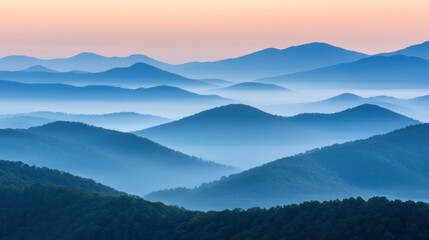 Fototapeta premium Rolling mountain ranges layered with misty atmospheric morning light