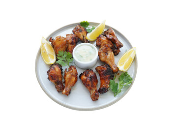 Grilled chicken leg and sauce ready to eat on a white plate