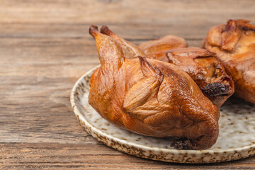 Tasty Smoked grilled quail meat with thyme on a wooden board