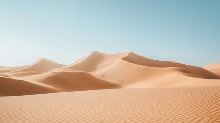 Vast desert dunes under a clear light blue and cloudless sky