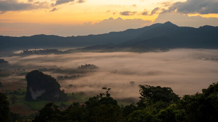 Dramatic sunset over mountain landscape. Beautiful landscape foggy hills twilight time. Blue golden sky sunrise dramatic beautiful landscape mountain. Dawn sky gold dusk time cloudscape with sunlight