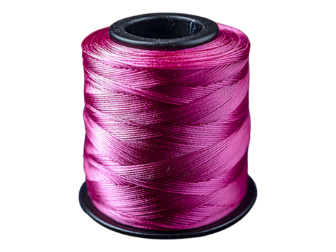 Closeup of a vibrant pink thread spool, surrounded by a blurred background of colorful thread spools.  A concept image representing creativity, craft, and textile artistry.