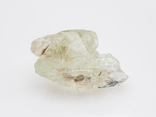 A raw, uncut specimen of pale green beryl crystal showcased against a clean, neutral background,...