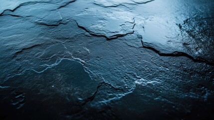 Dark, textured stone surface.  Close-up view of a slate or similar stone slab