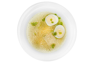 Chicken soup with egg and green peas isolated on a white background.