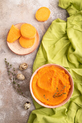 Sweet potato porridge in ceramic bowl on brown concrete. Diet, healthy eating. top view, close up