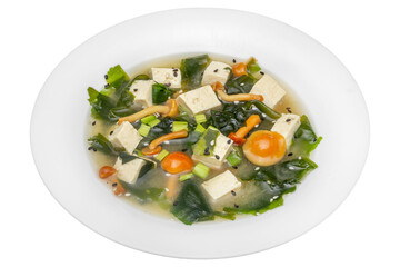 Soup with tofu and vegetables. Isolated over white background.