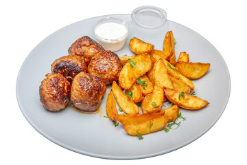 Meatballs with potatoes and sauce on a plate. Isolated over white background