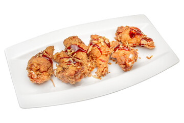 Deep fried chicken drumsticks on a plate isolated on a white background