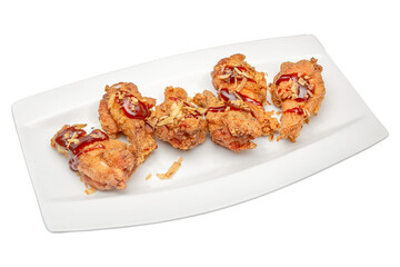 Deep fried chicken drumsticks on a plate isolated on a white background