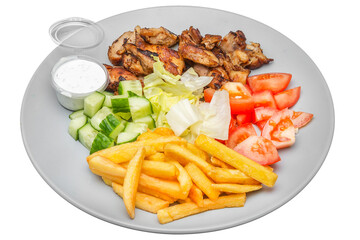 Plate with kebab, french fries and salad. Isolated over white background