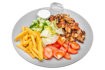 Plate with kebab, french fries and salad. Isolated over white background