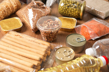 Different food products on wooden table, closeup