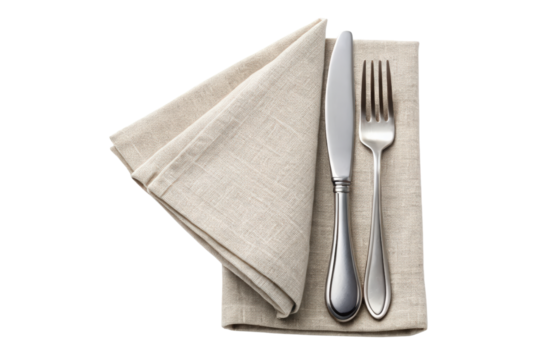 Elegant silver cutlery set placed on a folded linen napkin isolated with transparent background