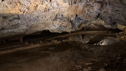 Fotobehang Chocoladebruin Mysterious cave interior with stalactites, adventure travel, spelunking exploration, natural wonder, geology, National Caves Week, rugged landscape  © fotoworld
