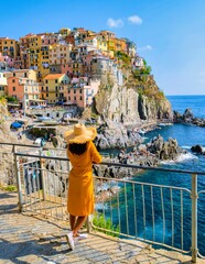 Visiting Manarola Village in Cinque Terre Coast Italy during summer with a stylish hat