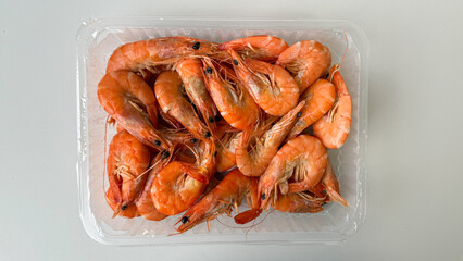 Fresh shrimp in plastic container, gourmet seafood cuisine, nutritional delicacy, perfect for summer barbecue and coastal dining experiences