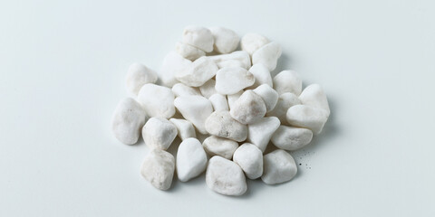 white stones on the white background. Isolated white pebbles