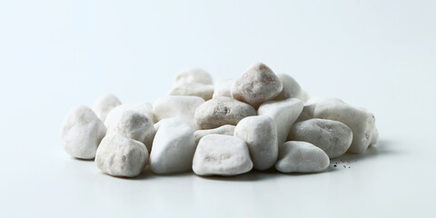 white stones on the white background. Isolated white pebbles