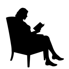 Silhouette of a woman reading a book in an armchair  