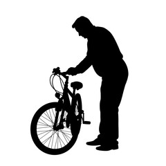 Obraz premium Man silhouette repairing bicycle against a plain background 