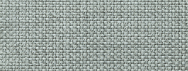 Texture light gray color background from woven textile material with wicker pattern, macro
