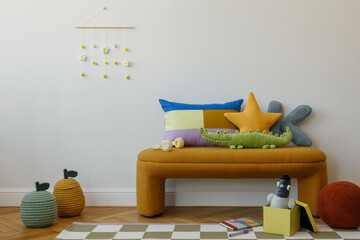 Minimalist compositions with soft toys and graphic pillows arranged on a mustard bench under a...