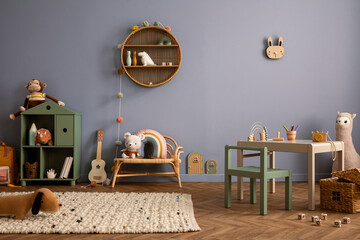 Cozy composition of kid room interior with round shelf, gray desk, green armchair, blue wall,...
