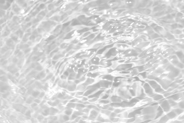 White water with ripples on the surface. Defocus blurred transparent white colored clear calm water surface texture with splashes and bubbles. Water waves with shining pattern texture background.