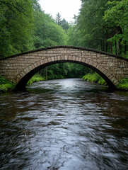 A charming old stone bridge over a gentle river surrounded by forest, ideal for countryside travel brochures.