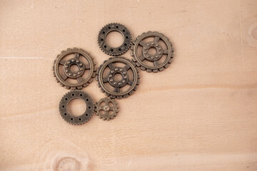 Steampunk gear arrangement on wooden background, creating retro-futuristic and industrial feel,...