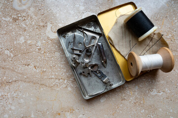 Tools of the trade from bygone era of textile craft, Vintage sewing machine parts in tin, retro craft tools, metal components