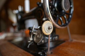 Vintage black sewing machine detail, retro craftsmanship, old technology, mechanical parts, historical object, sewing and tailoring