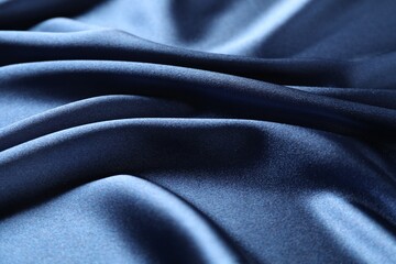 Fototapeta premium Blue crumpled silk fabric as background, closeup