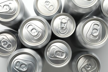 Many different tin cans on light background, top view