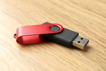 One flash drive on wooden background, closeup