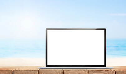 laptop with blank screen for copy space stands on table against sea background