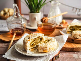 Traditional asian rice cake with honey and green tea on a wooden background